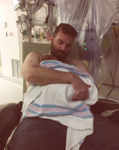 New father holds son.